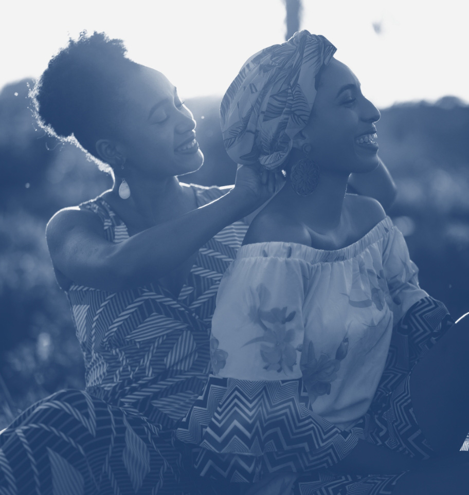 A stylized image of a woman helping another woman put on a headdress.